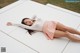 A woman laying on a white platform in a park.